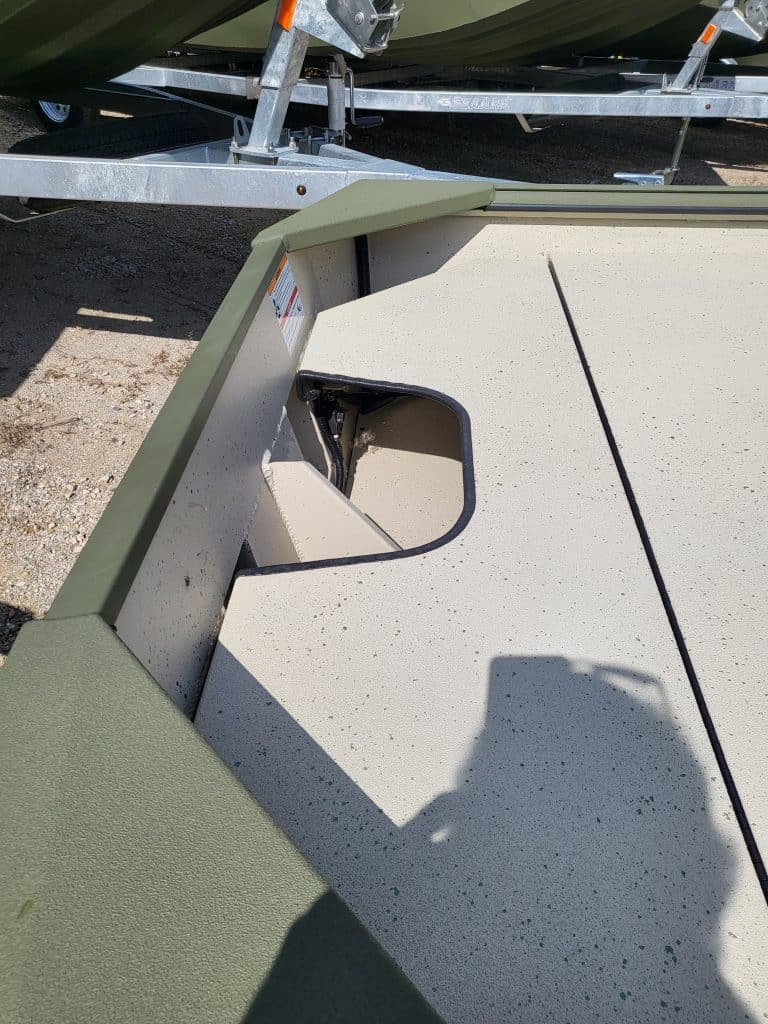 Outdoor fishing boat with trailer at Camp & Cruise, perfect for anglers and boating enthusiasts.