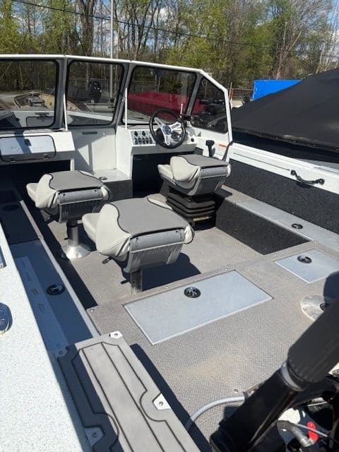 Boat cockpit with steering wheel and seating at Camp & Cruise.