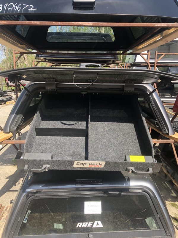 Durable roof cargo box for sports gear storage, ideal for outdoor sports trips at Camp & Cruise.