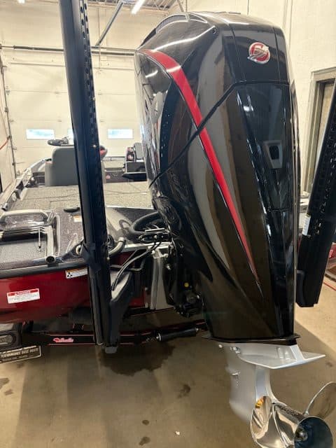 High-performance black outboard motor with red accents for boats.