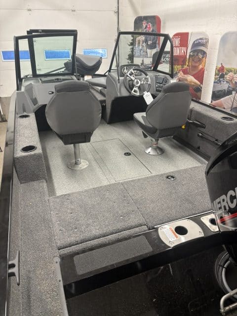 Boat cockpit with steering wheel and dashboard at Hall's Sport Center.